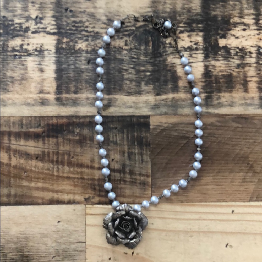 Real pearl necklace with rose pendant.